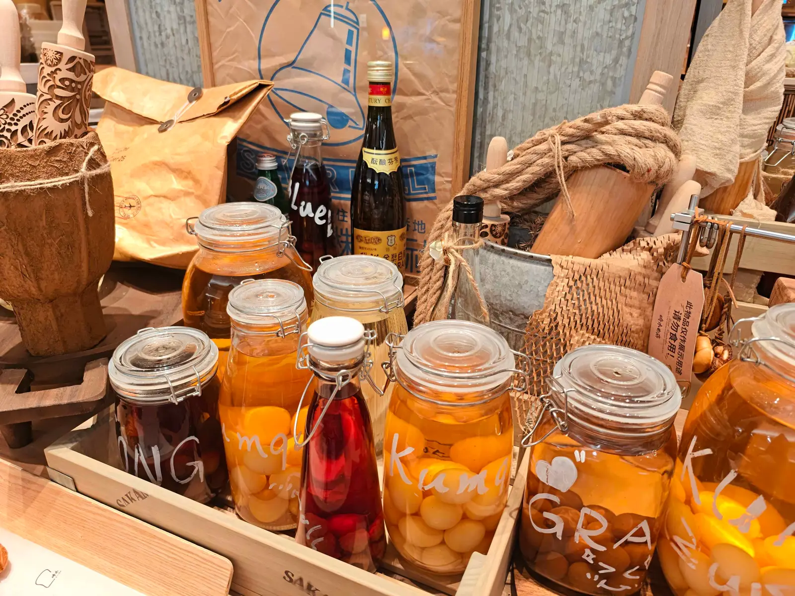 Clip-top jars of kumquats and plums preserved in syrup